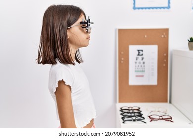 Young Hispanic Girl Wearing Optometry Glasses Looking To Side, Relax Profile Pose With Natural Face With Confident Smile. 