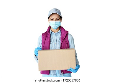 Young hispanic latin woman courier worker wears medical face mask, gloves looking at camera delivering parcel holding delivery box in hands concept stand isolated on white studio background. Portrait