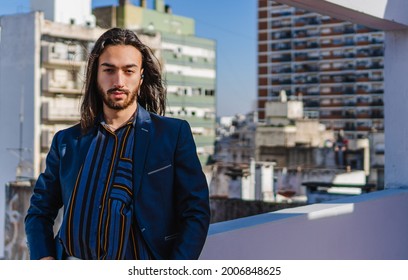 Young Hispanic Latino Male Long Haired Businessman Using Wireless Headset, Looking At Camera. Copy Space