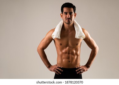 Young Hispanic Male Athlete With Towel On Neck And Hands On Hips