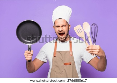 young hispanic man angry expression. chef concept