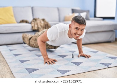 Young hispanic man army soldier training push up at home - Powered by Shutterstock