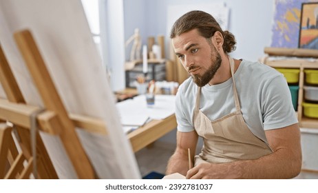 Young hispanic man artist drawing at art studio - Powered by Shutterstock