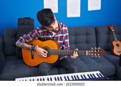 Young Hispanic Man Artist Playing Classical Guitar At Music Studio