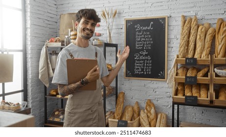 Young hispanic man with beard and clipboard in bakery shop pointing at chalkboard menu with pastries and bread in background against white brick wall - Powered by Shutterstock