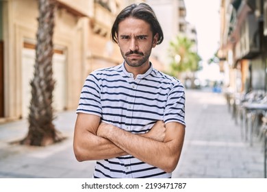 Young Hispanic Man With Beard Outdoors At The City Skeptic And Nervous, Disapproving Expression On Face With Crossed Arms. Negative Person. 