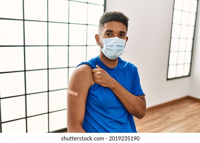 Young Hispanic Man With Beard Wearing Safety Mask Getting Vaccine Thinking Attitude And Sober Expression Looking Self Confident 