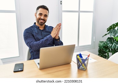 Young Hispanic Man With Beard Working At The Office With Laptop Clapping And Applauding Happy And Joyful, Smiling Proud Hands Together 