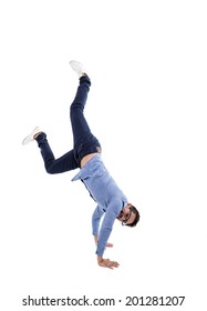 Young Hispanic Man With Blue Shirt And Glasses Doing A Cartwheel Isolated Over White