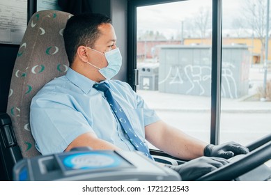 Young Hispanic Man Bus Driver Has Blue Medical Protection Mask And Black  Gloves On Hands To Protect Himself From Covid 19. Driver In Mask Looks At The Road.