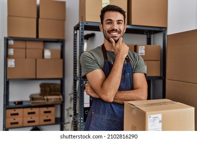 Young hispanic man business worker smiling confident standing at storehouse - Shutterstock ID 2102816290