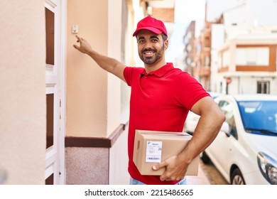 Young Hispanic Man Courier Holding Package Press Doorbell At Street