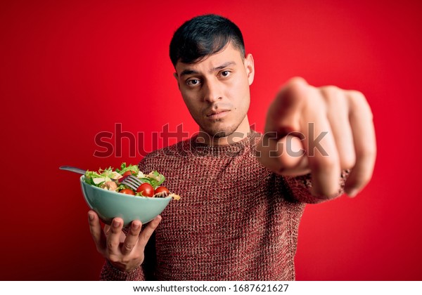 young-hispanic-man-eating-vegetarian-healthy-stock-photo-1687621627