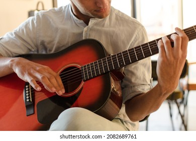 Young Hispanic Man Guitar Class Concept