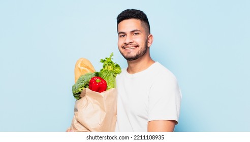 Young Hispanic Man Happy Expression. Shopping Vegetables Concept