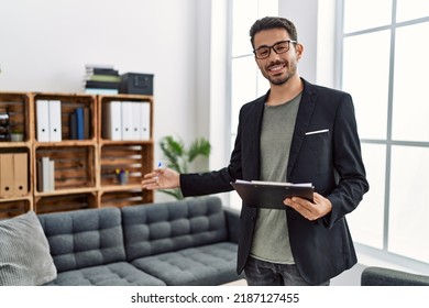 Young hispanic man having psychology session holding checklist welcoming patient at clinic - Shutterstock ID 2187127455