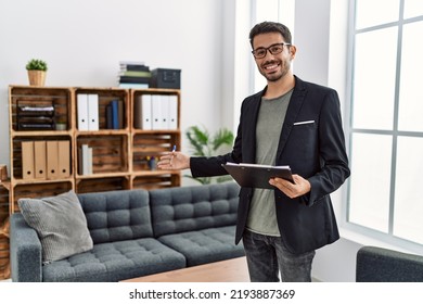 Young hispanic man having psychology session holding checklist welcoming patient at clinic - Shutterstock ID 2193887369