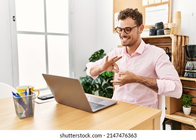 Young Hispanic Man Having Video Call Communicating With Deaf Sign Language At Office