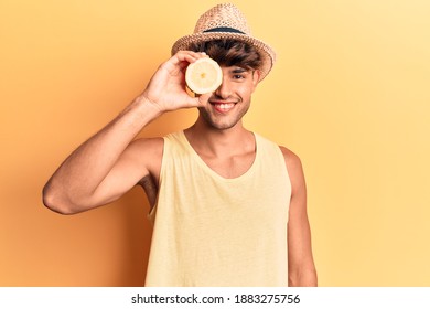 Young hispanic man holding lemon looking positive and happy standing and smiling with a confident smile showing teeth  - Powered by Shutterstock