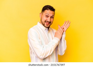 Young hispanic man isolated on yellow background feeling energetic and comfortable, rubbing hands confident. - Powered by Shutterstock