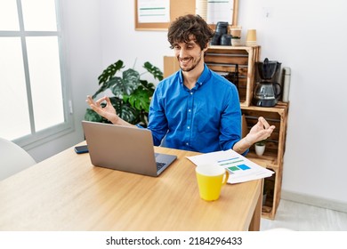 Young Hispanic Man Meditating Doing Yoga Exercise At Office