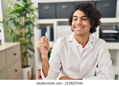 Young Hispanic Man Optician Holding Eye Drop At Clinic