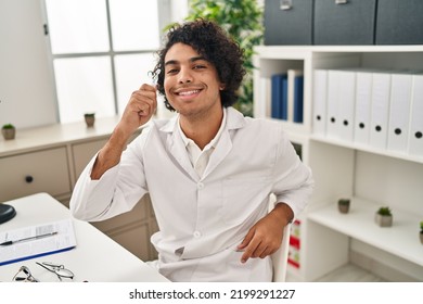 Young Hispanic Man Optician Holding Eye Drop At Clinic