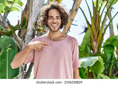 Young Hispanic Man Outdoors On A Sunny Day Pointing Finger To One Self Smiling Happy And Proud 