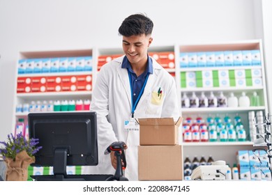 Young Hispanic Man Pharmacist Scanning Pills At Pharmacy