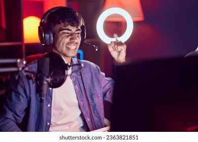 Young hispanic man playing video games screaming proud, celebrating victory and success very excited with raised arm  - Shutterstock ID 2363821851