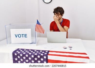 Young Hispanic Man At Political Election Sitting By Ballot Tired Rubbing Nose And Eyes Feeling Fatigue And Headache. Stress And Frustration Concept. 