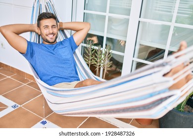 Young hispanic man relaxed smiling happy lying on the hammock at terrace. - Powered by Shutterstock