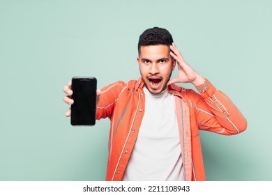 Young Hispanic Man Scared Expression And Holding A Mobile Phone