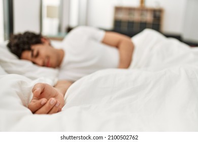 Young hispanic man sleeping lying on the bed at bedroom.