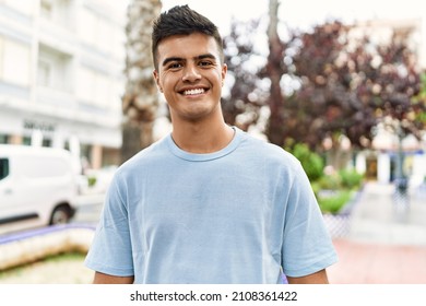 Young hispanic man smiling confident standing at street - Shutterstock ID 2108361422