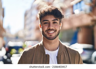 Young hispanic man smiling confident standing at street - Shutterstock ID 2186403417