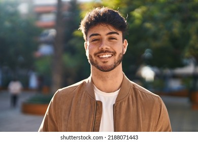Young hispanic man smiling confident standing at park - Shutterstock ID 2188071443