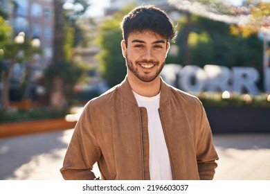 Young hispanic man smiling confident standing at park - Shutterstock ID 2196603037