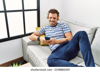 Young hispanic man smiling confident listening to music at home
