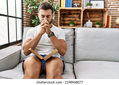 Young Hispanic Man Smiling Confident Praying At Home