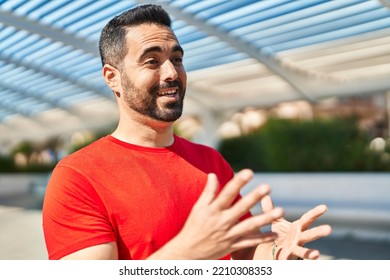 Young Hispanic Man Smiling Confident Speaking At Street