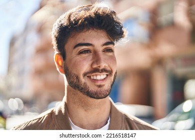 Young hispanic man smiling confident looking to the side at street - Shutterstock ID 2216518147