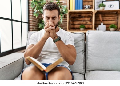 Young Hispanic Man Smiling Confident Praying At Home