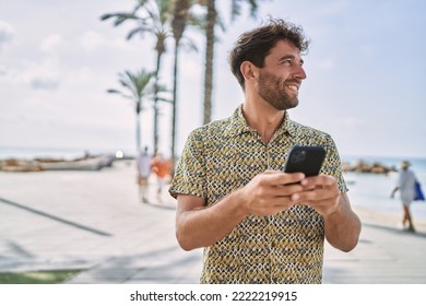 Young hispanic man smiling confident using smartphone at seaside - Powered by Shutterstock