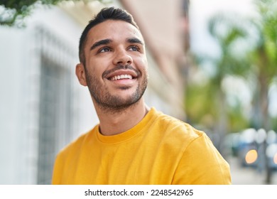 Young hispanic man smiling confident looking to the sky at street - Shutterstock ID 2248542965