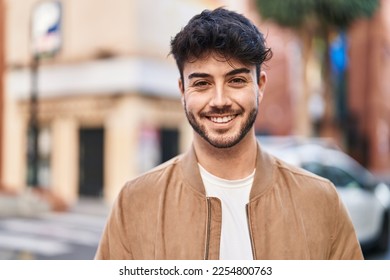 Young hispanic man smiling confident standing at street - Powered by Shutterstock