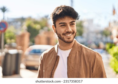 Young hispanic man smiling confident looking to the side at street - Powered by Shutterstock