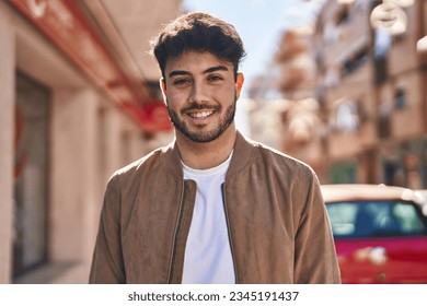 Young hispanic man smiling confident standing at street - Shutterstock ID 2345191437
