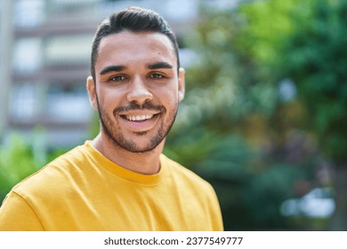 Young hispanic man smiling confident standing at park - Powered by Shutterstock