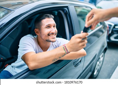 Young Hispanic Man Smiling Happy Holding Key Of New Car